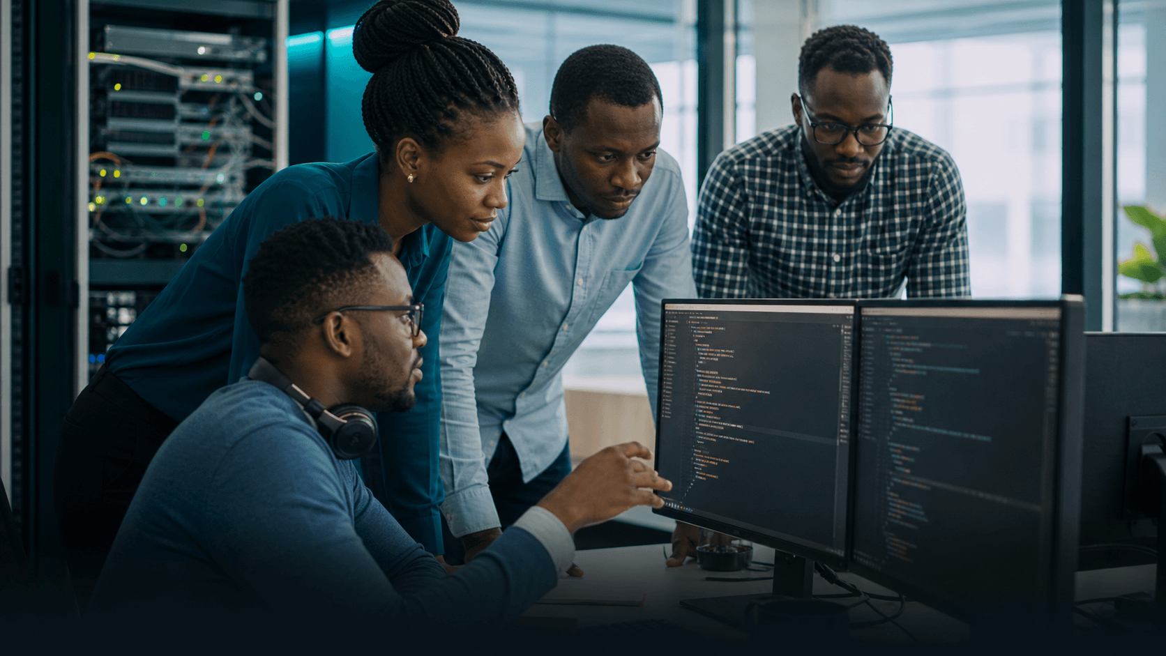 Salticon technology professionals collaborating beside server infrastructure and software systems